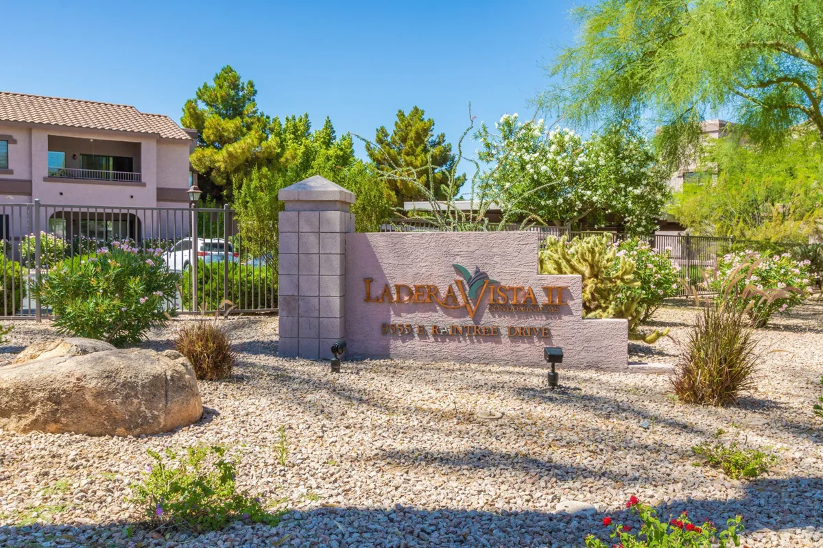 An inviting exterior shot featuring the property’s sign surrounded by well-kept landscaping and rock features. The scene captures a sense of friendly community while emphasizing outdoor relaxation and the welcoming nature of the complex.